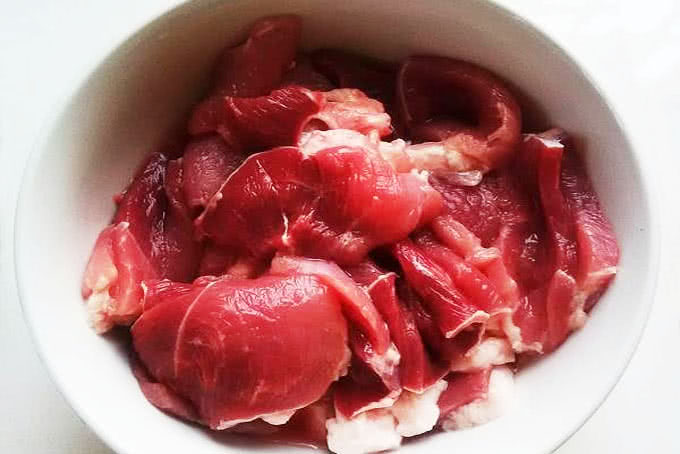 Thịt rửa sạch thái miếng mỏng khoảng 2-3mm, để riêng vào một bát lớn.